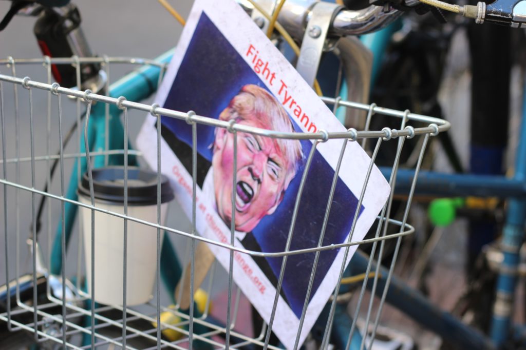 A protest sign featuring an angry Donald Trump inside a basket. 
